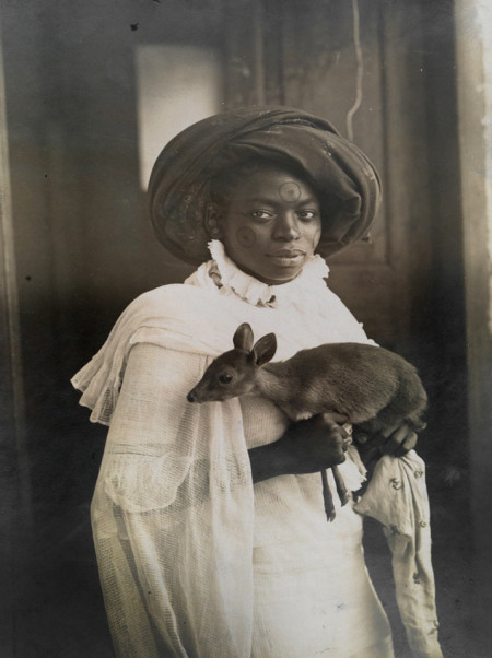 A young Kenyan woman holds her pet deer in Mombassa, March 1909