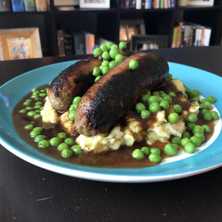 Bangers and mash with gravy and peas