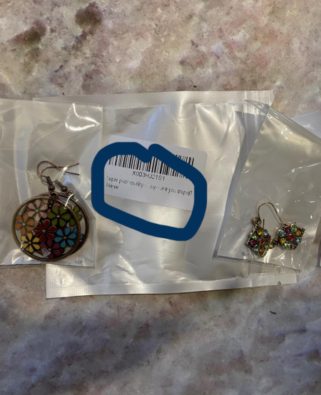 These earrings bought on Amazon are labeled “Super poor quality…by, are you stupid? ”