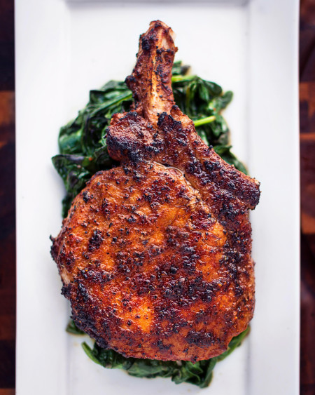 Bone-in Pork Chop over sautéed spinach