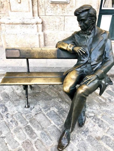 Chopin sitting on a bench