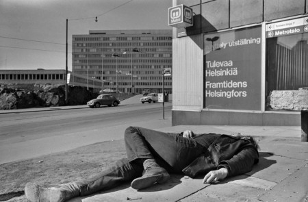 A drunkard lying in front of a sign that says &quot;Exhibition, Helsinki of the future. &quot; Finland 1974