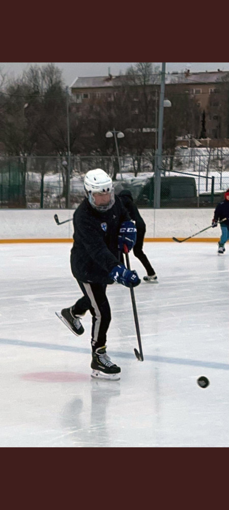 The president of Finland Sauli Niinistö playing ice hockey on a public rink