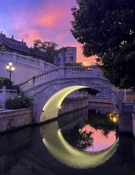 The lighting under this bridge that makes it look like a Crescent-Moon in the water