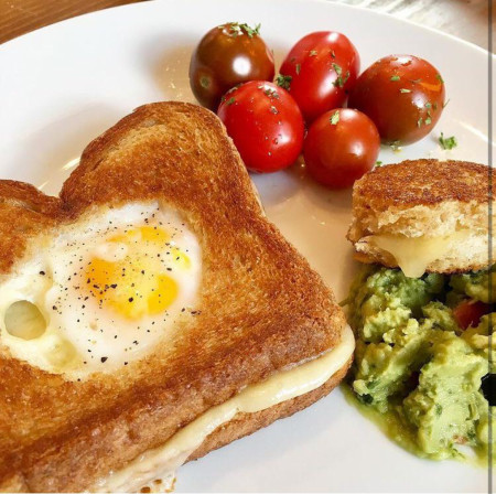 Egg in a hole with Neals Yard Dairy Montgomery’s cheddar, homemade guac, home garden tomatoes