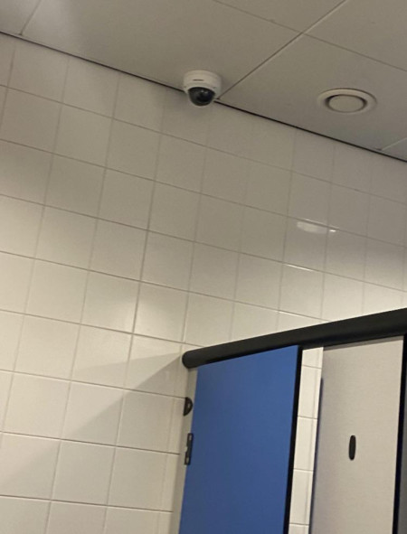 This camera right above a bathroom stall