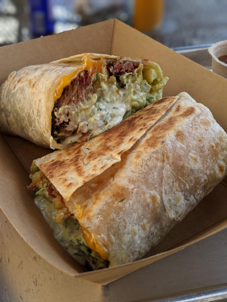 California-style burrito stuffed with smoked barbacoa, fries, guac, cheddar, and jalapeno crema