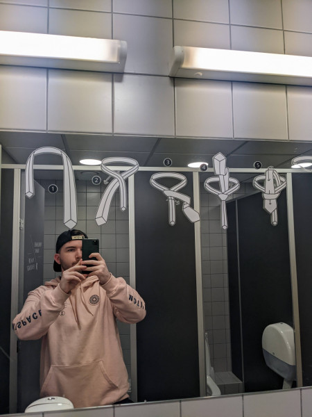 This bathroom mirror in Tallinn Airport has instructions on how to tie a tie