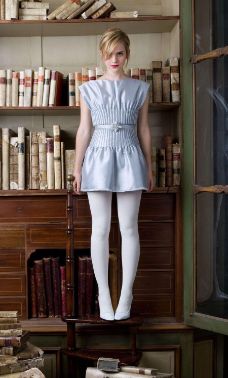 Emma in white tights in a library