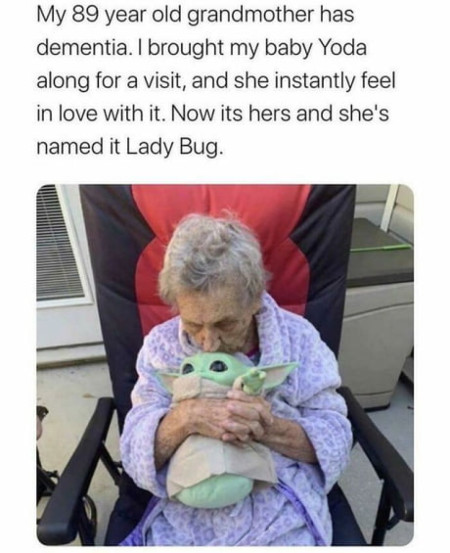 A person brings a doll to grandma with dementia