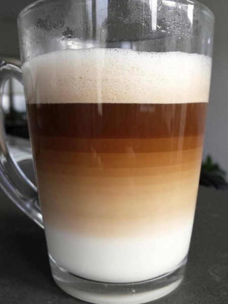 A brown-white color gradient on this cup of coffee