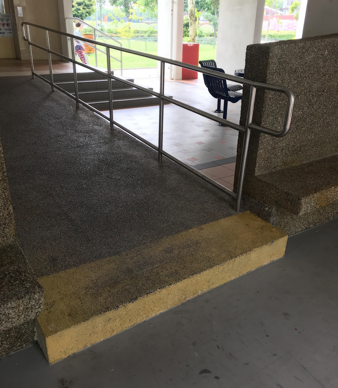 Wheelchair ramp with a step