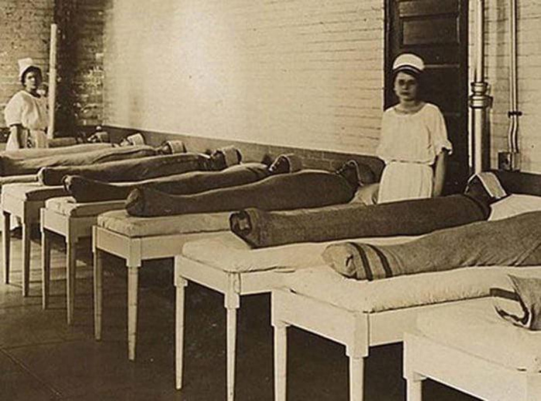 Nurses standing with mentally ill patients in wet linens. Thought to be calming for them