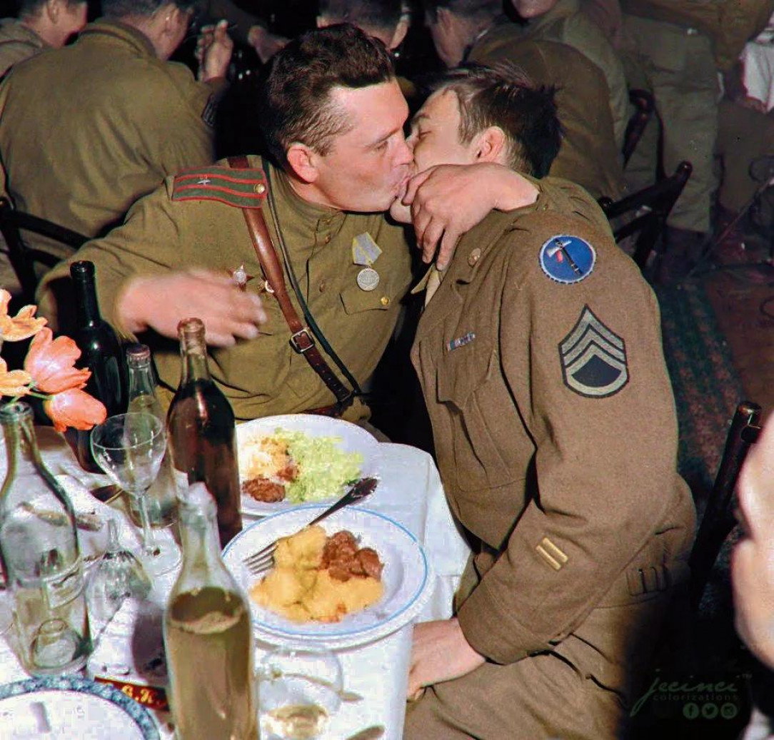 An American and Soviet Soldier kissing each other to celebrate their WW2 victory, 1945