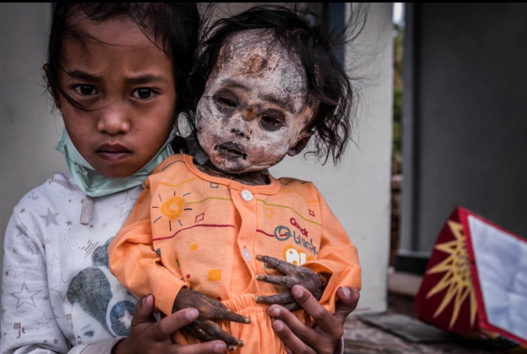 In a mountainous area of Indonesia, the Toraja people mummify the bodies of the deceased and care for their preserved bodies as though they are still living. Pictured here, Clara poses with her dead sister Arel, who died when she was six