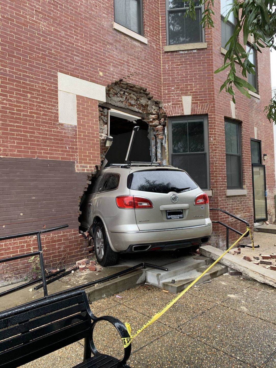 Car gets stolen, and the driver rams through the entrance of a brick building