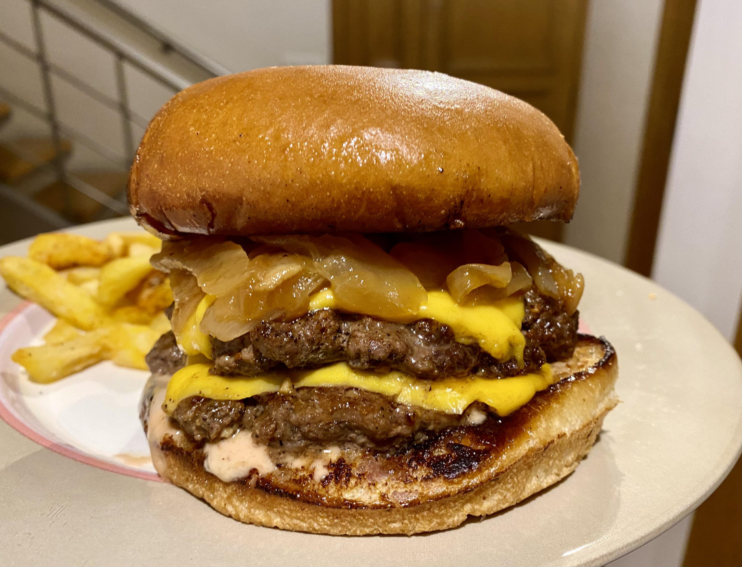 Homemade double cheeseburger with caramelized onions