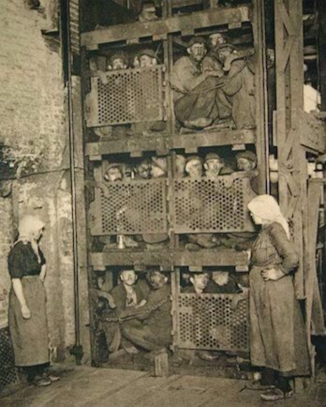 Coal miners coming up in a coal mine elevator after a day of work in Belgium 1920&#039;s