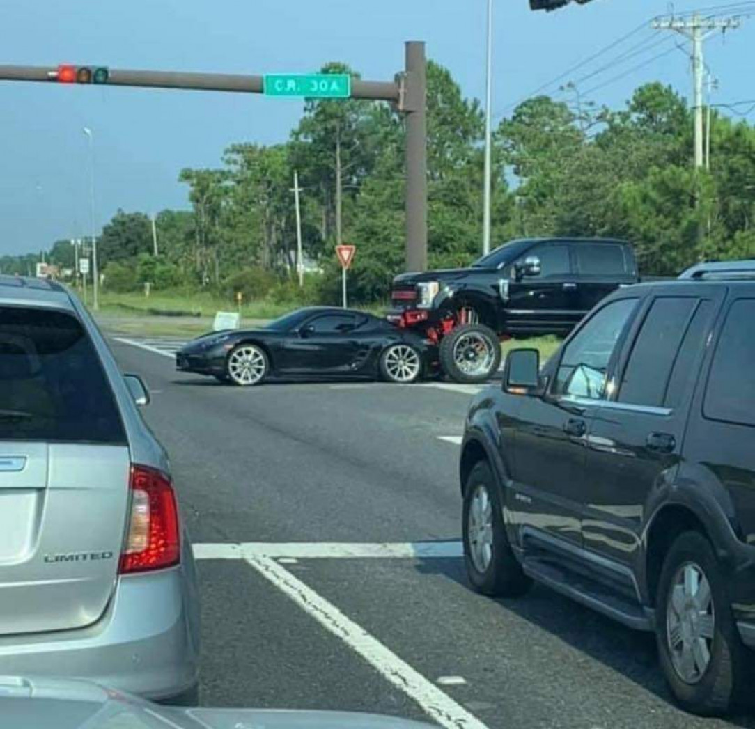 Truck lifted too high to see the Porsche in front of him