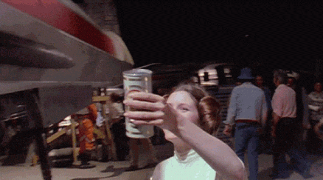 Carrie Fisher handing Mark Hamill a beer (1980)