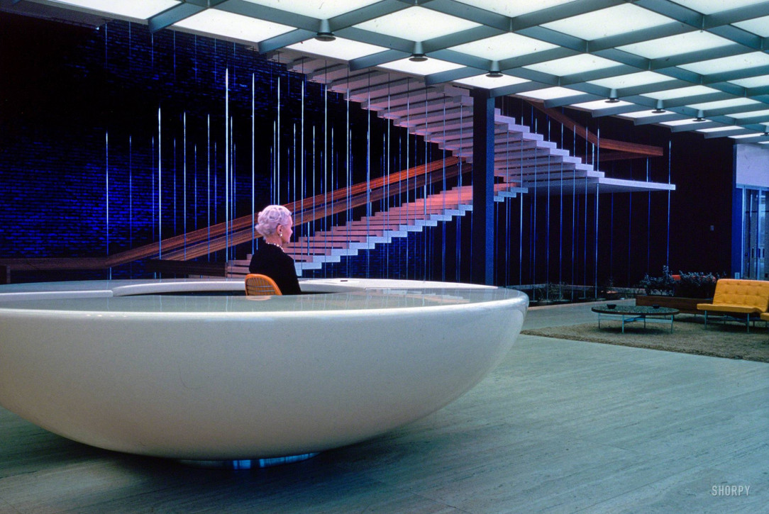 Receptionist waits at her desk. General Motors Technical Center, 1965