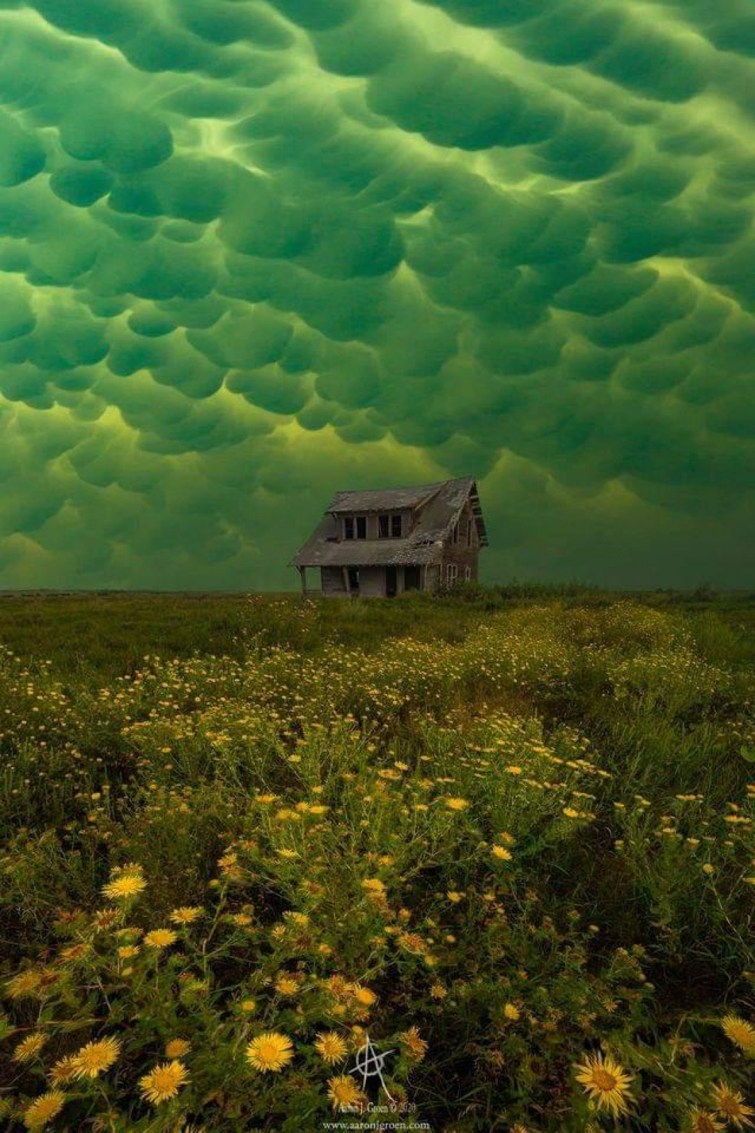 Green mammatus clouds, which usually precede a tornado, over an abandoned house