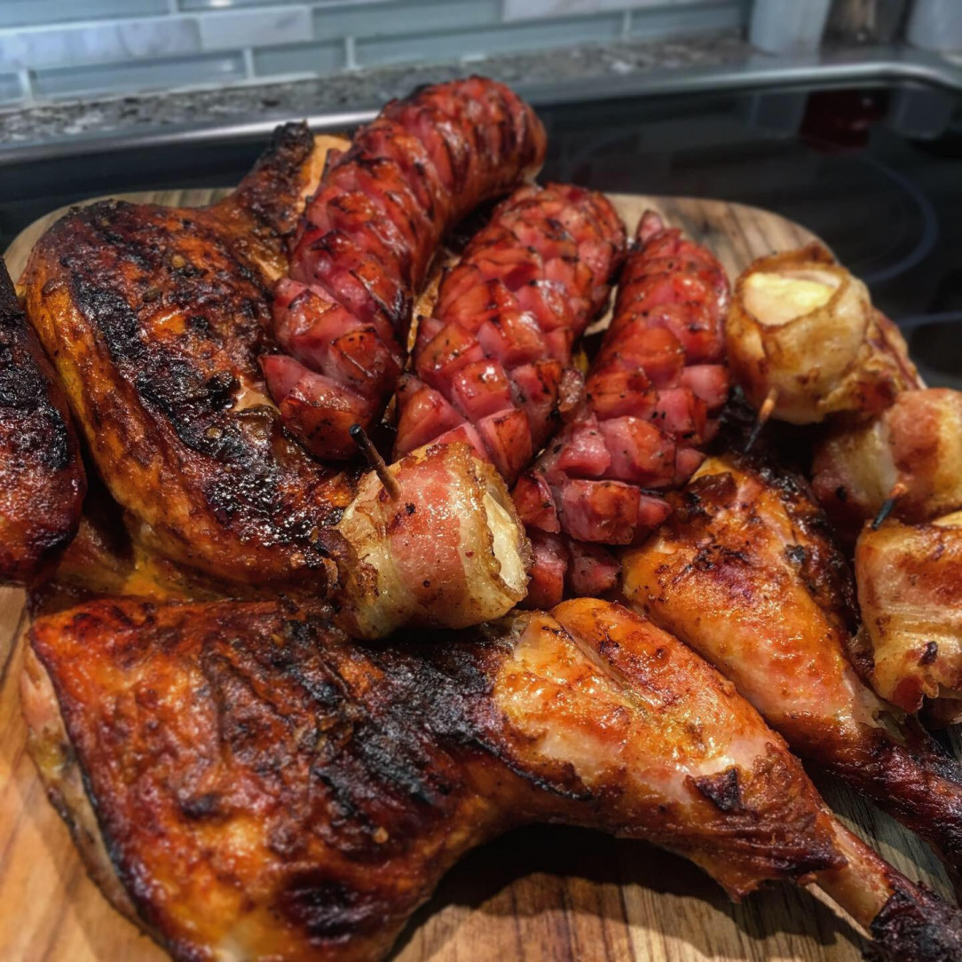 Peri peri chicken with bacon wrapped halloumi cheese and diamond cut sausages