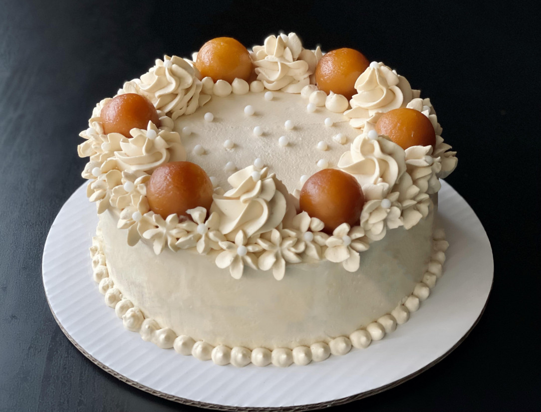 Homemade cardamom cake with whipped cream and gulab jamuns