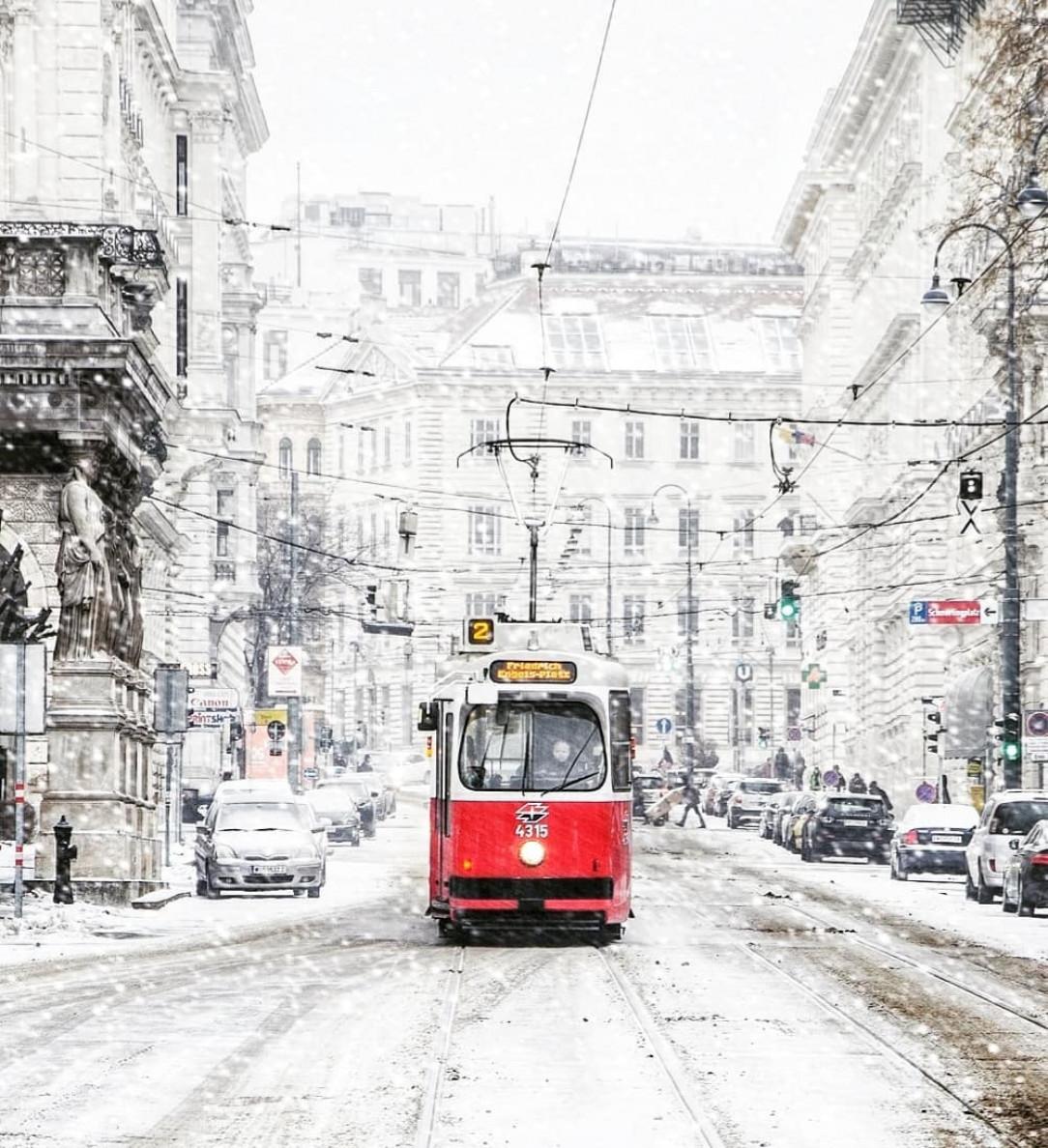 Red tram car in the snow, Vienna, Austria