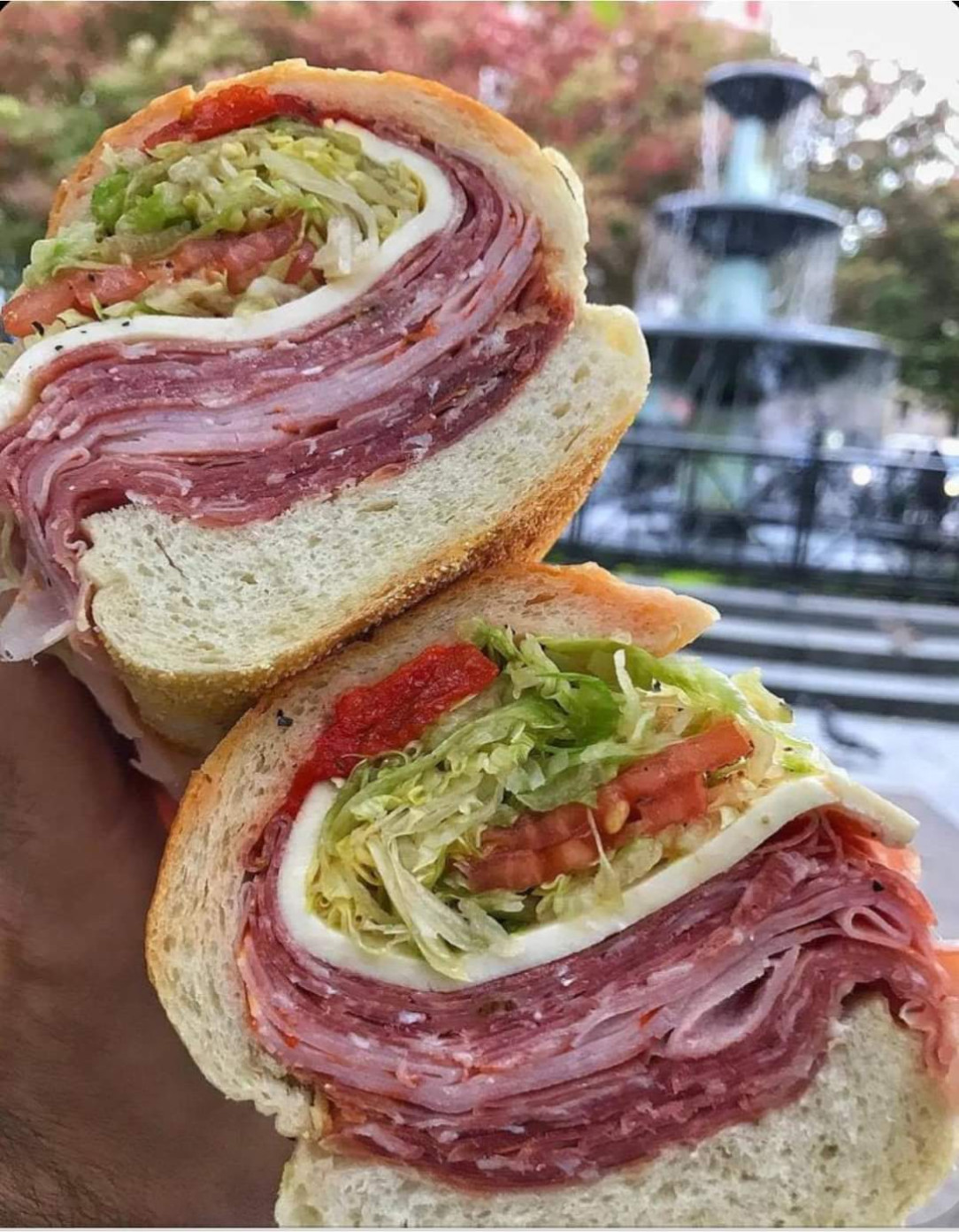 Italian stylesandwich with 3 types of salami and salad