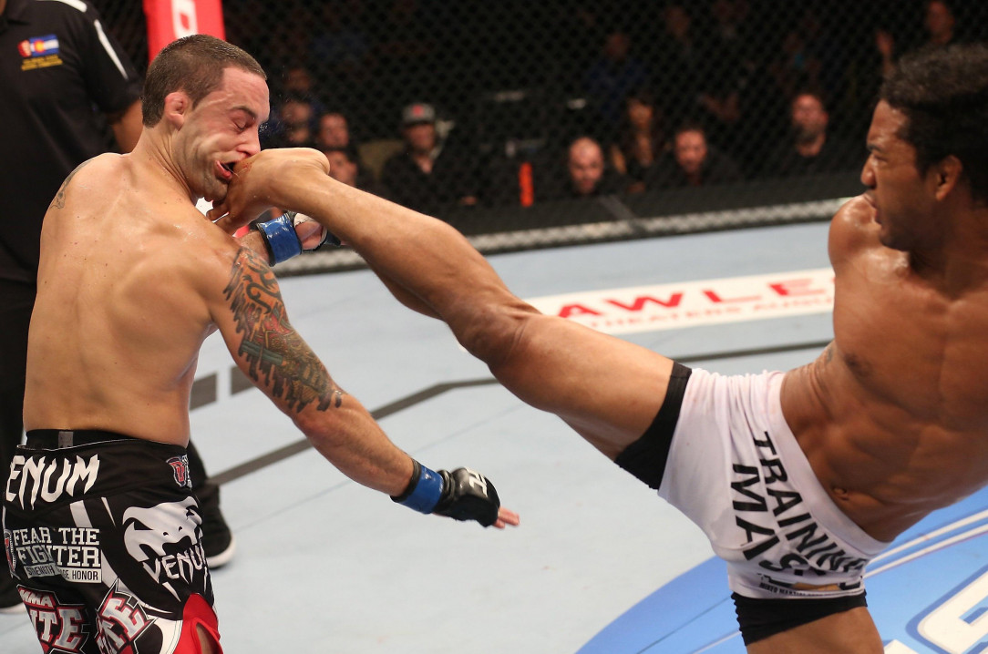 A still shot image of Benson Henderson kicking Frankie Edgar in the face