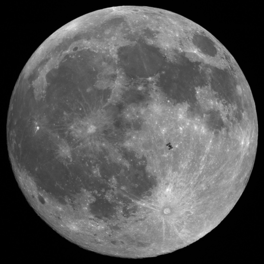 The International Space Station in front of the full moon