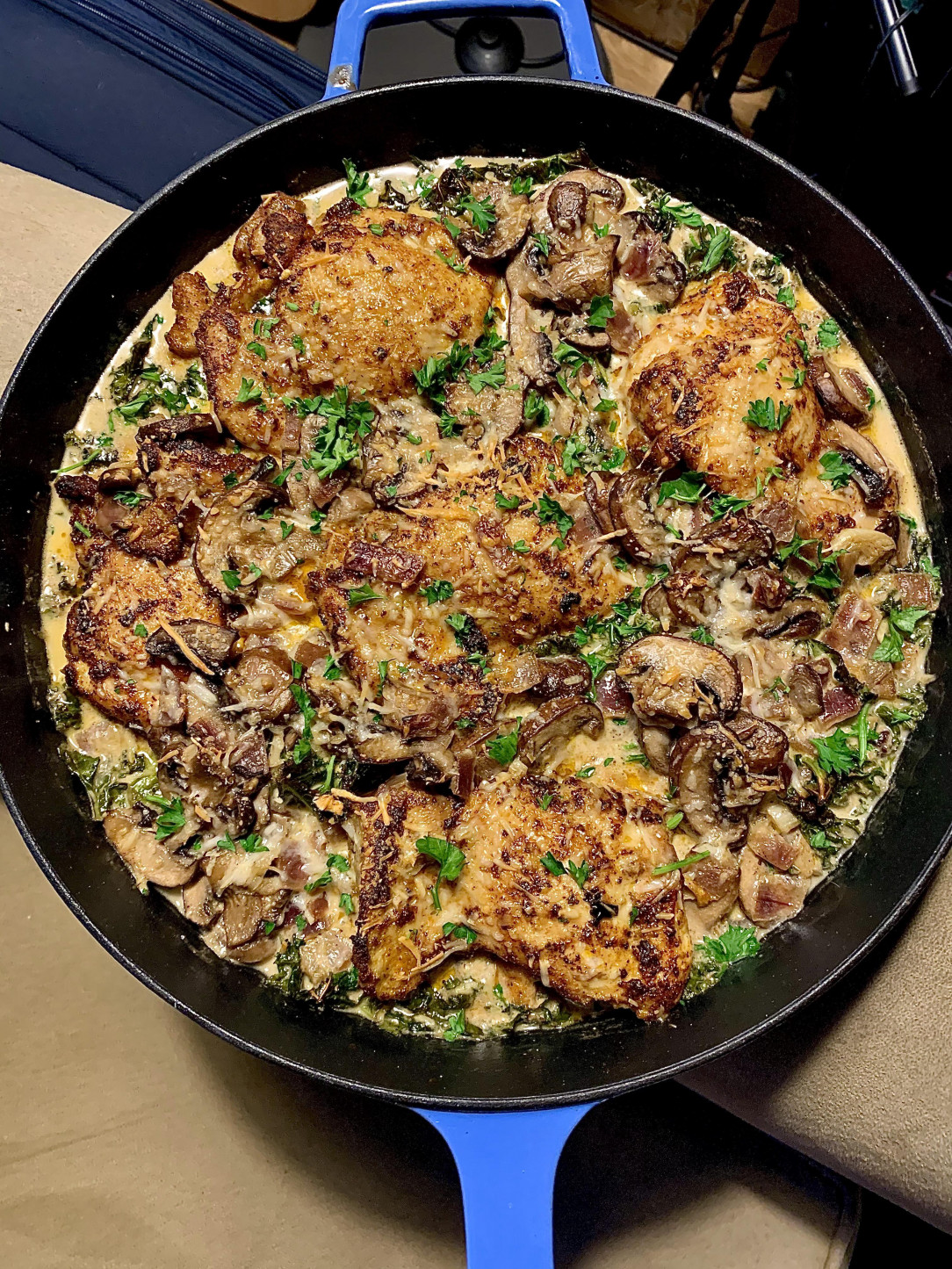 Chicken thighs in a mushroom, kale cream sauce