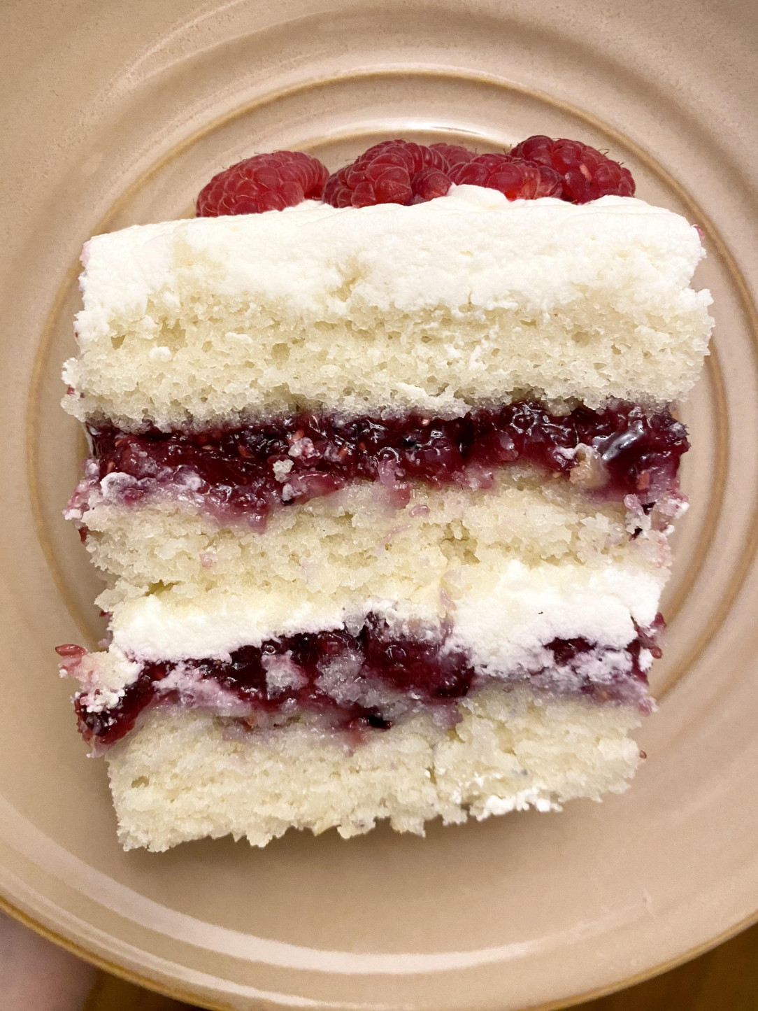 Homemade vanilla cake with mixed berry filling and vanilla mascarpone frosting