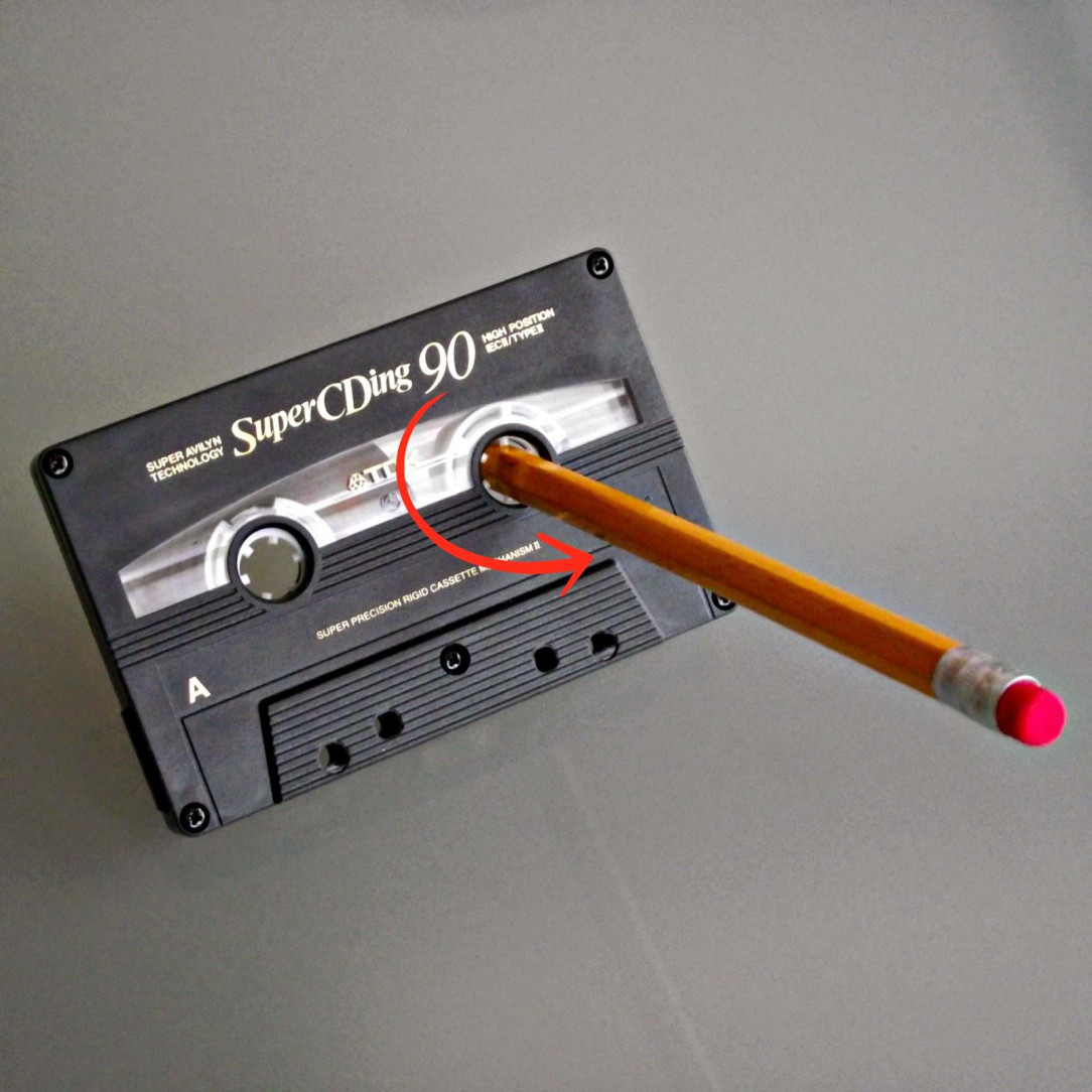 Using a pencil to fix a cassette tape that had its tape come loose