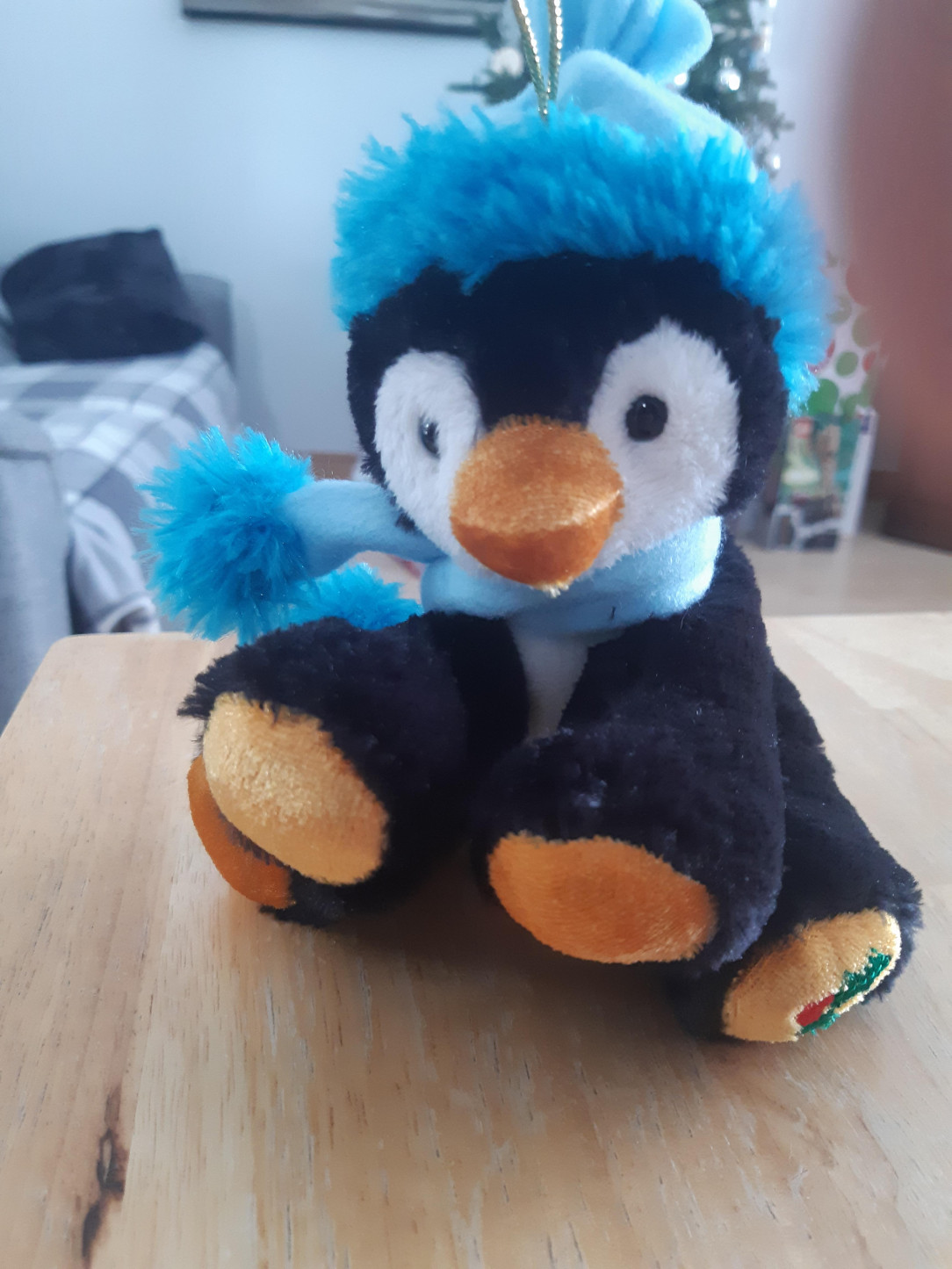 This plush of a penguin has 4 paws like a bear