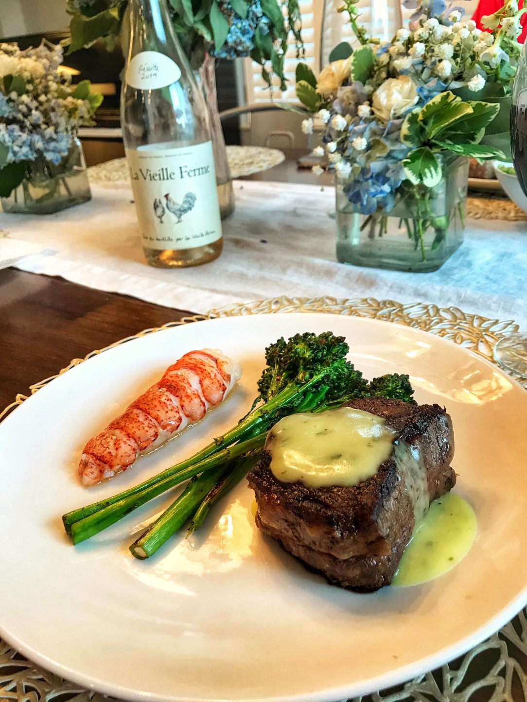 Surf n’ Turf. Butter basted wagyu filet, sous vide lobster tail in butter with tarragon, and grilled broccolini served with béarnaise