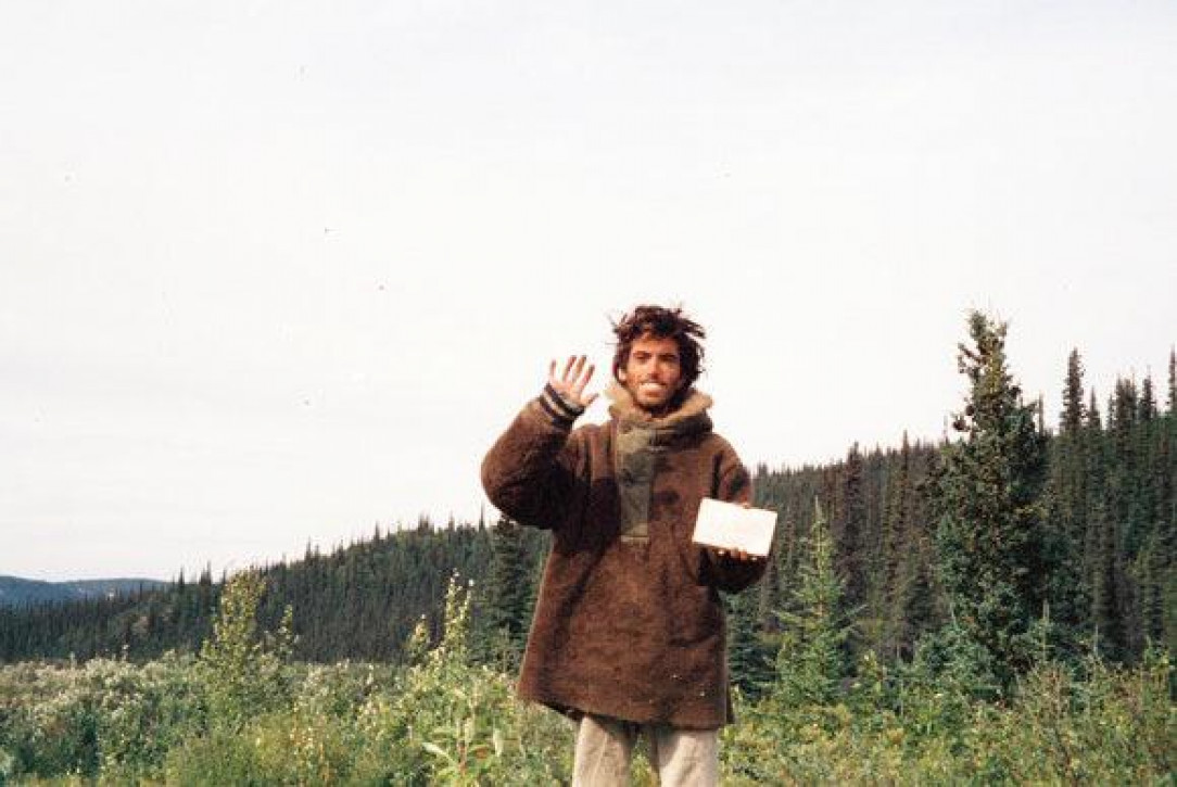 Adventurer Chris McCandless, days before his death by starvation in the Alaskan wilderness, posing with a goodbye note