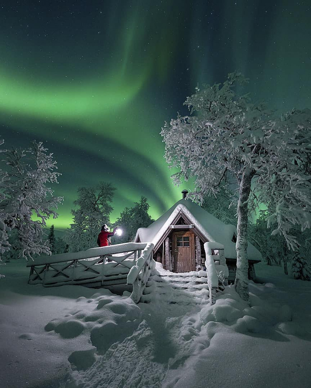 Aurora borealis over a small cabin in Lapland, Finland