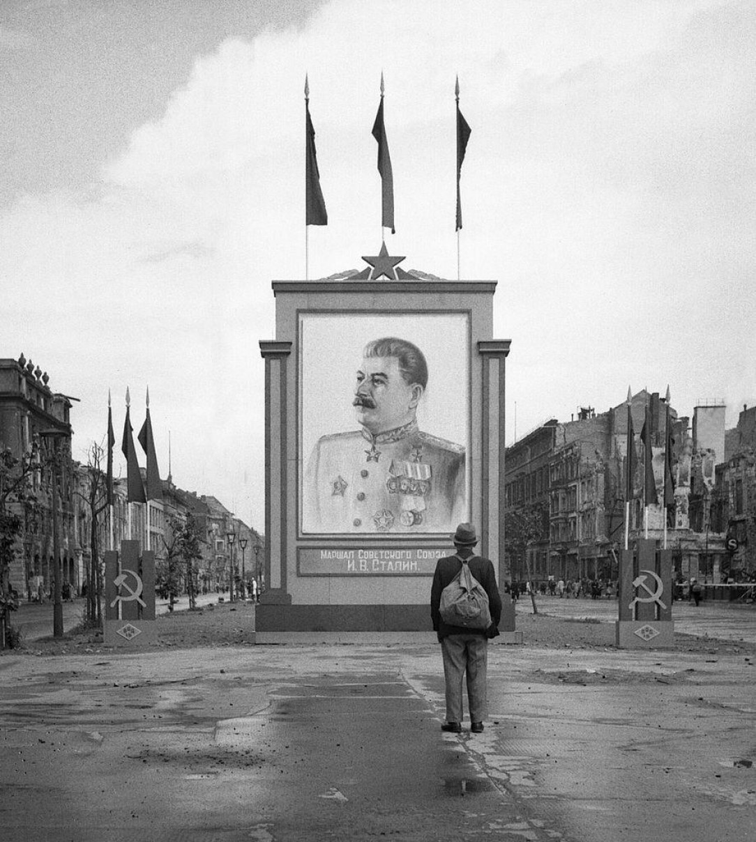 A German civilian looks at a large poster portrait of Stalin on the Unter-den-Linden in Berlin, 3 June 1945