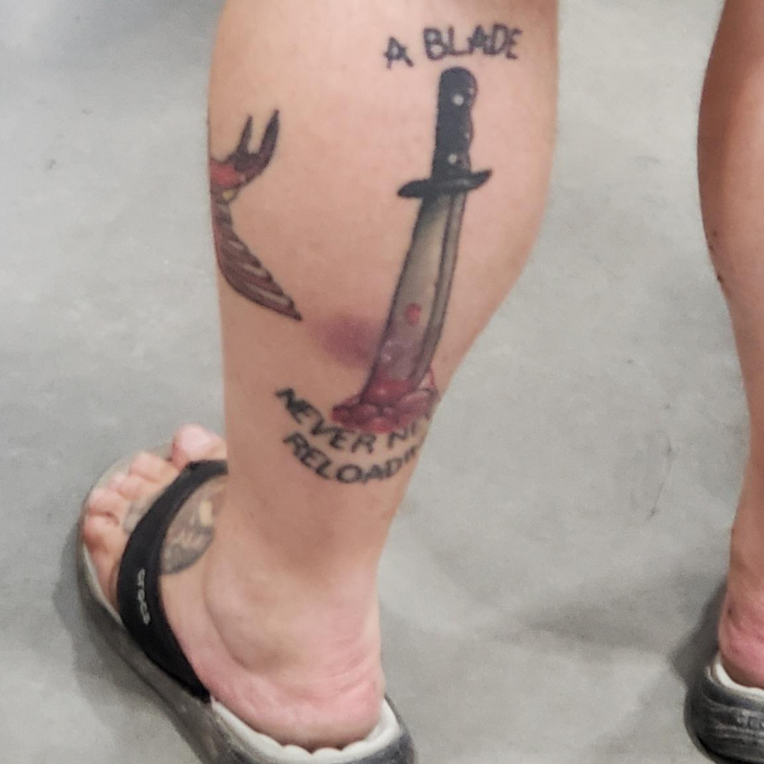 &quot;A Blade Never Needs Reloading&quot; bloody tattoo over flip-flops