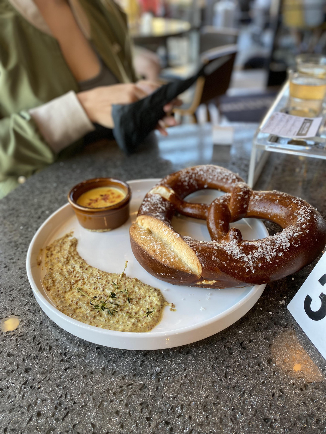 Pretzel with mustard spread and beer cheese dip