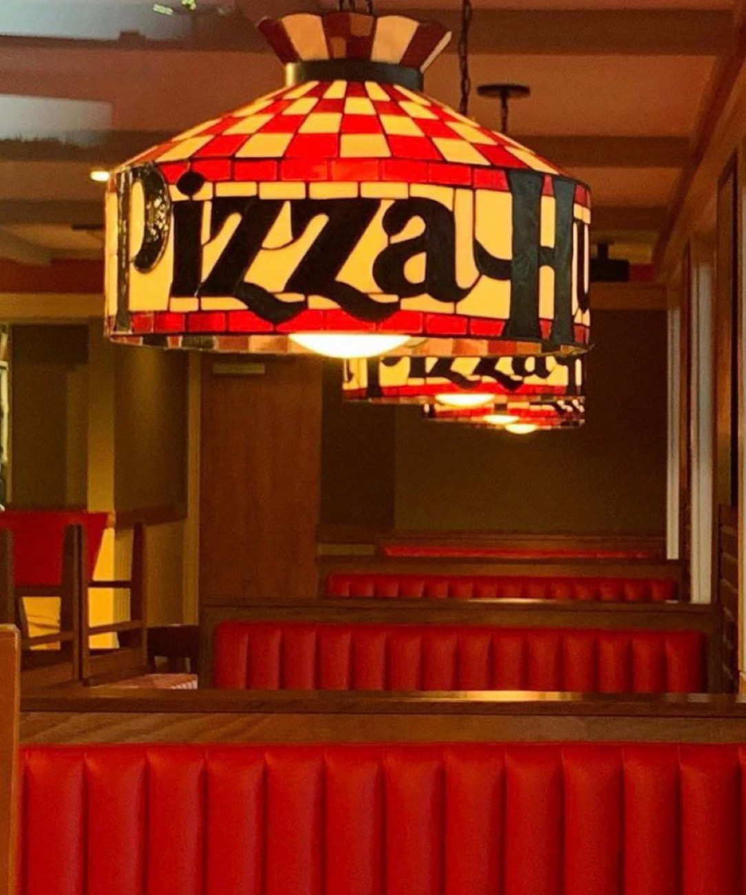 80s kids remember sitting in a booth under a Pizza Hut lamp feeling like royalty about to have an extravagant feast