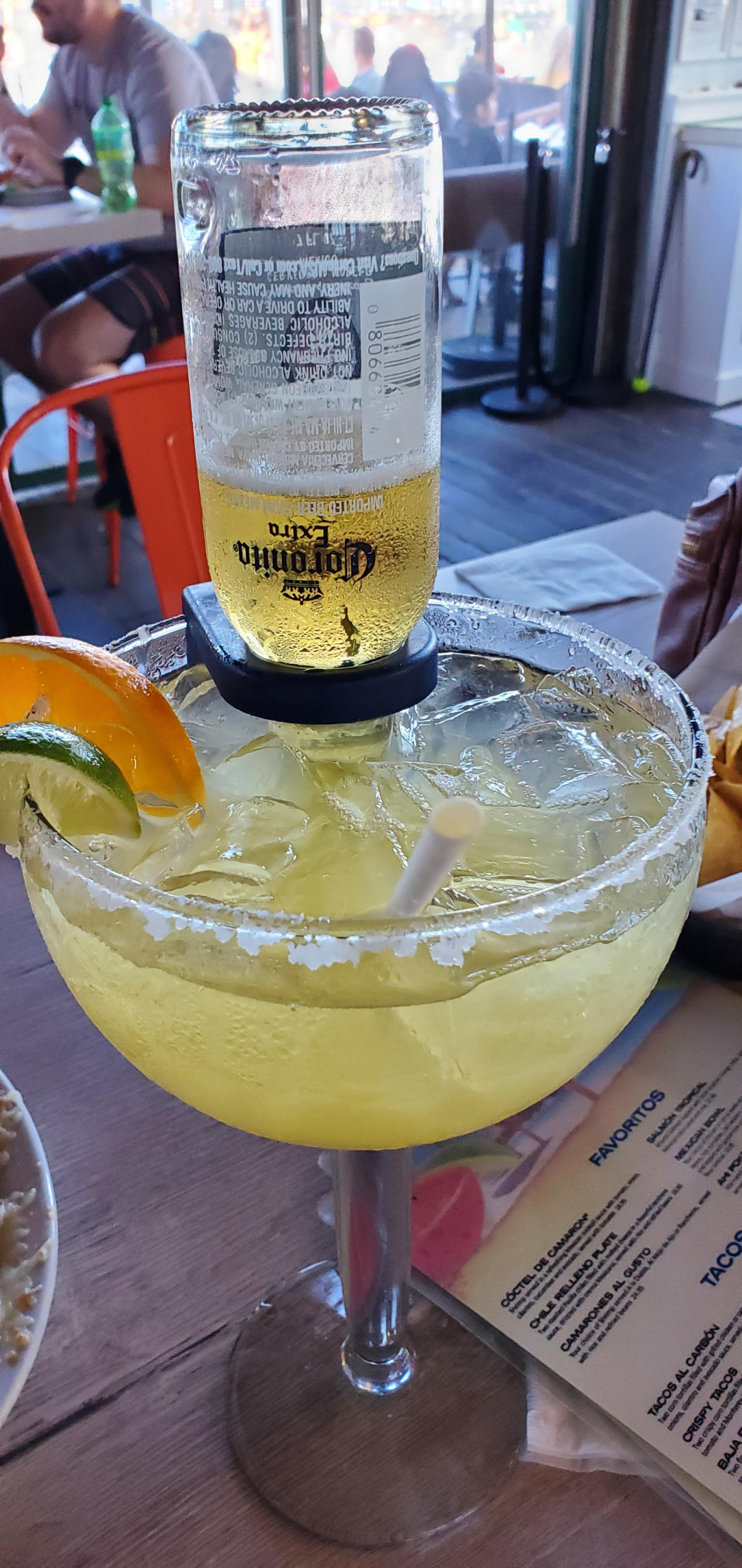 Coronarita Physics: what forces keep the beer from draining to margarita level?